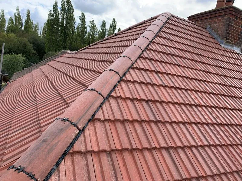 Roofing tiles being re-laid on a residential property